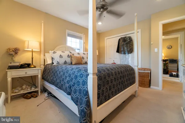 a bedroom with a bed and a mirror