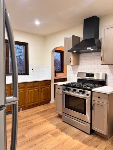 a kitchen with stainless steel appliances a stove a sink and a microwave