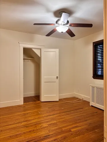 a bedroom with a bed dresser and a chandelier