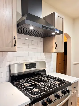 a stove top oven sitting inside of a kitchen