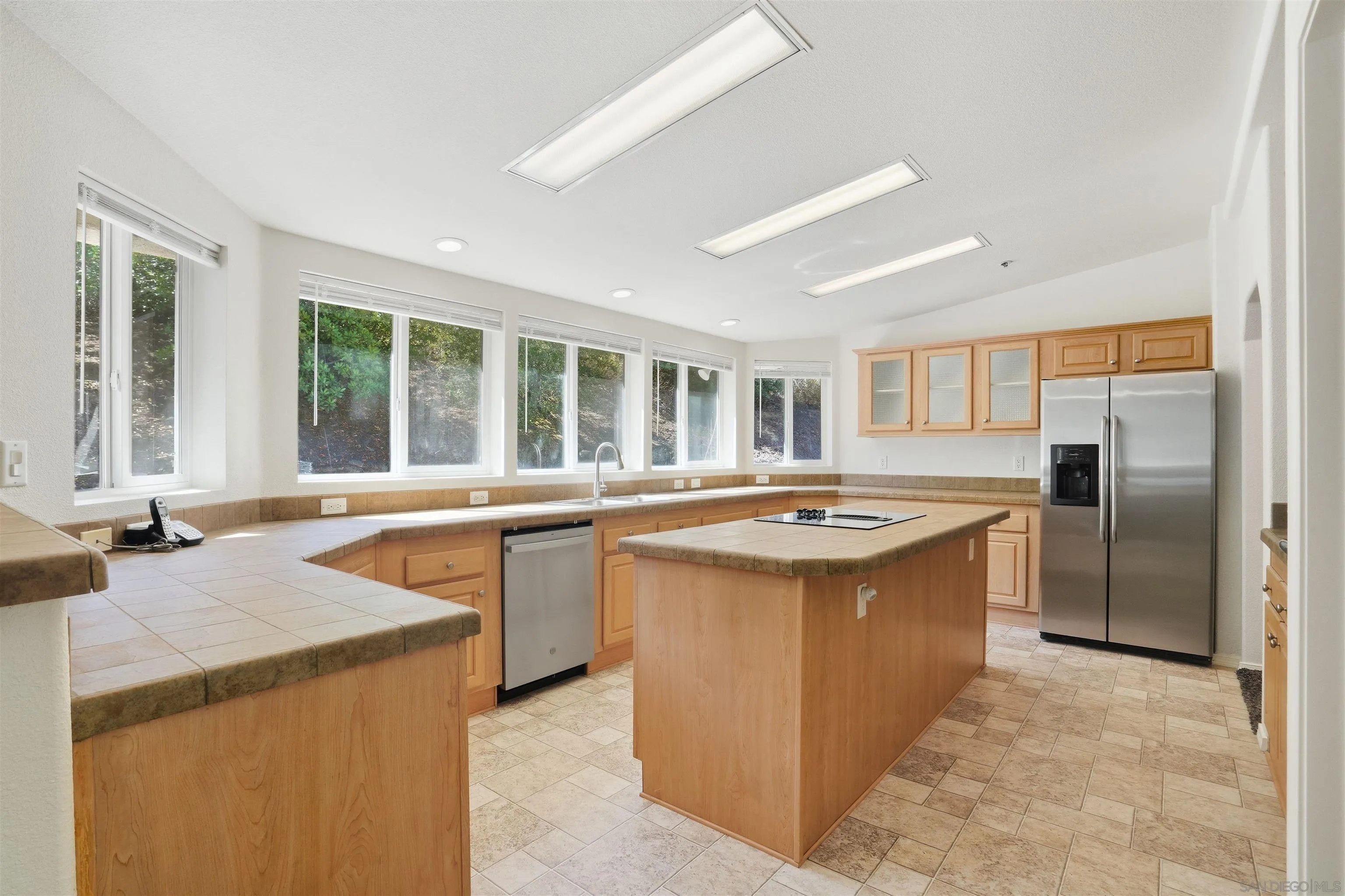 a kitchen with stainless steel appliances granite countertop a sink and a stove