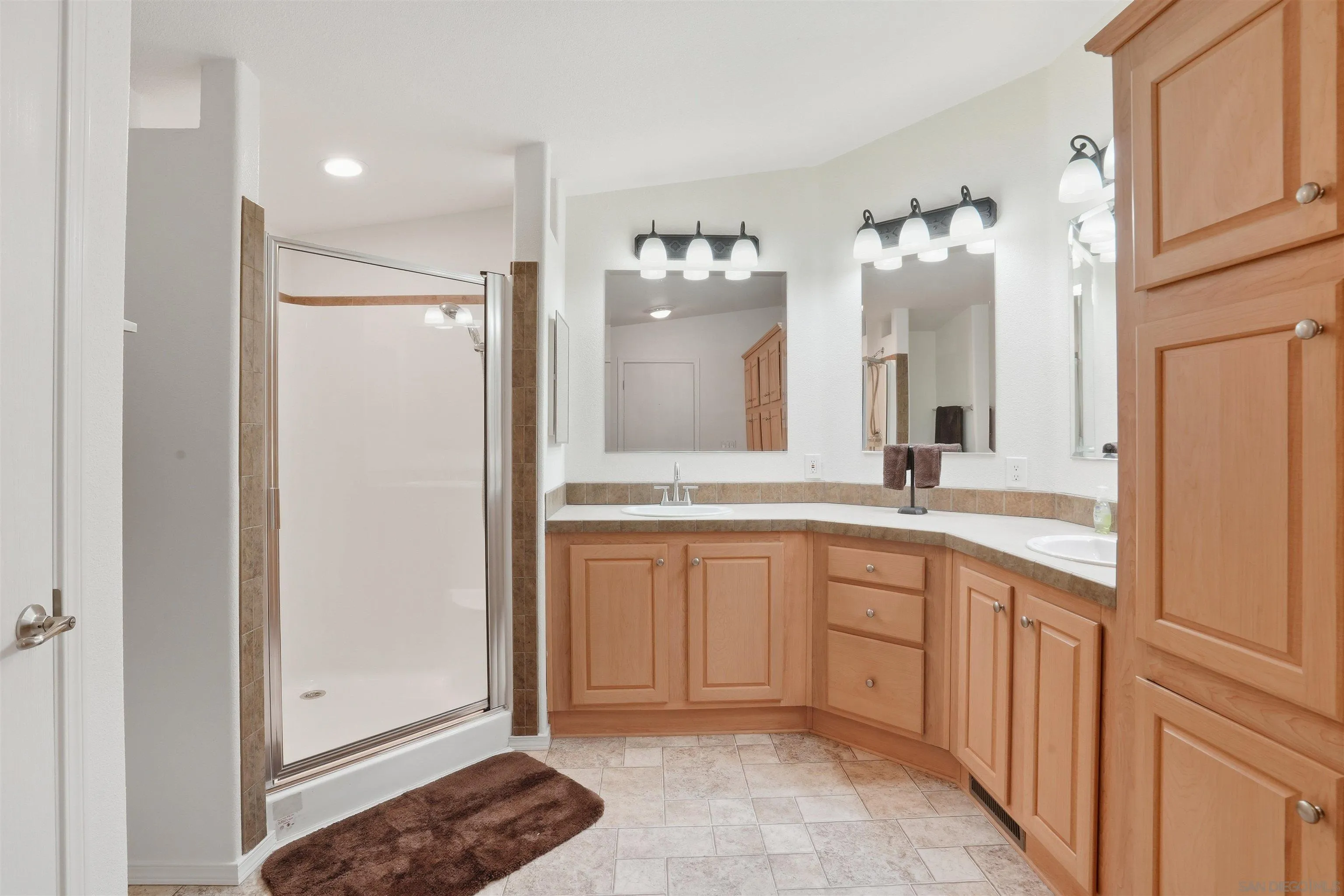 15453 Woods Valley Road Valley Center, CA 92082 - Photo 19 of 38 a spacious bathroom with a double vanity sink and a mirror