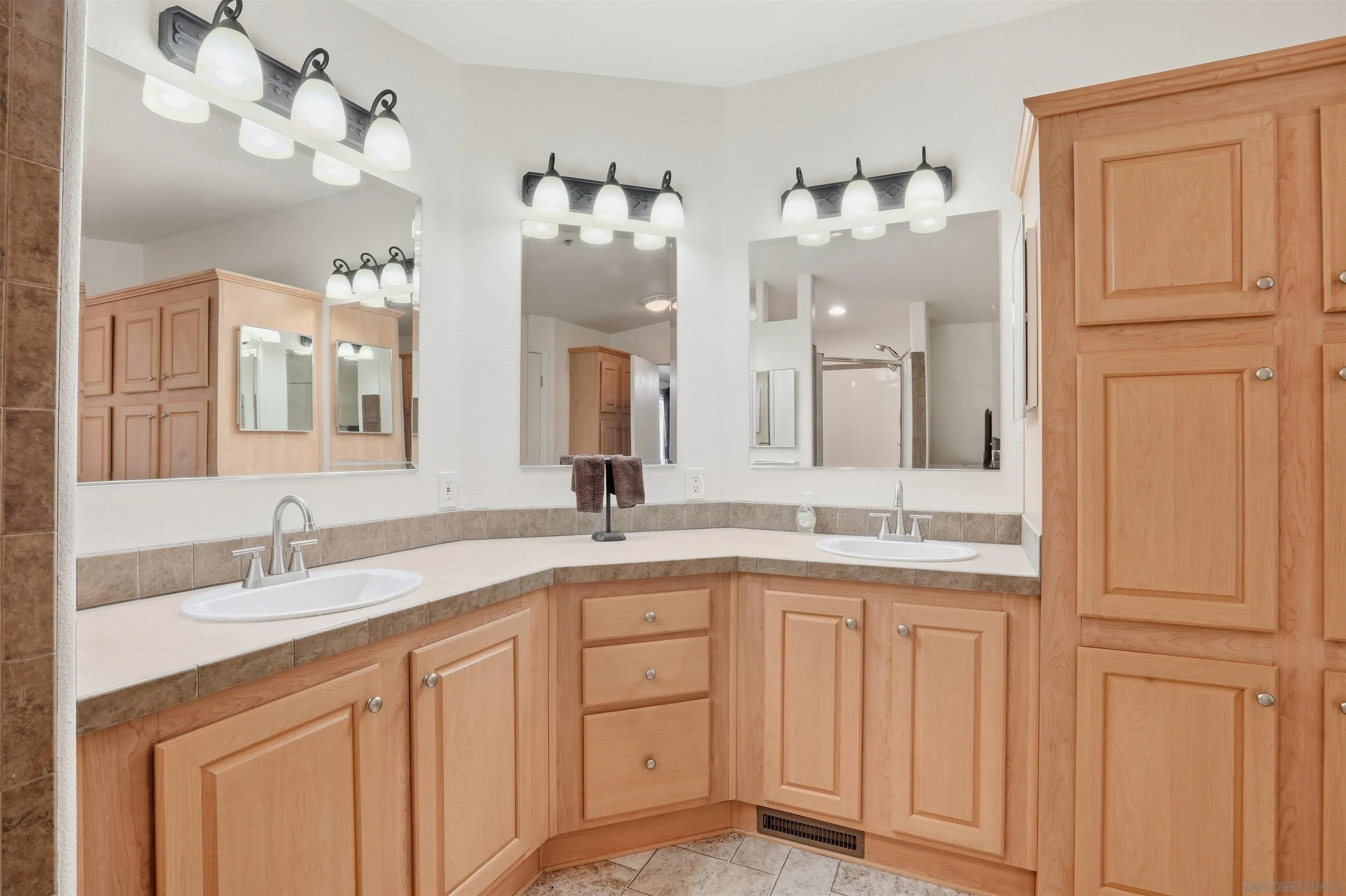 15453 Woods Valley Road Valley Center, CA 92082 - Photo 20 of 38 a bathroom with a double vanity sink and a mirror