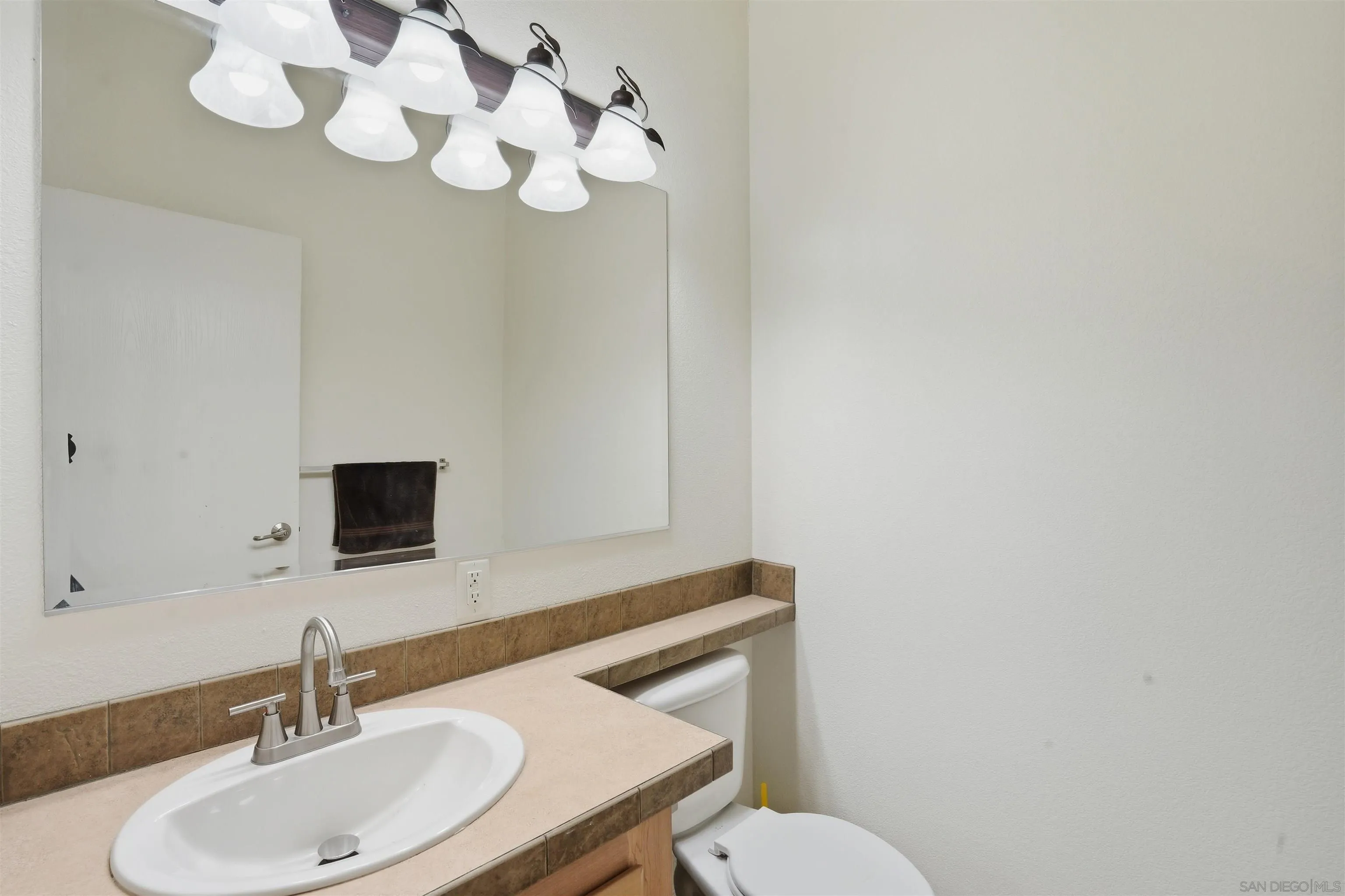 15453 Woods Valley Road Valley Center, CA 92082 - Photo 22 of 38 a bathroom with a sink a mirror and vanity