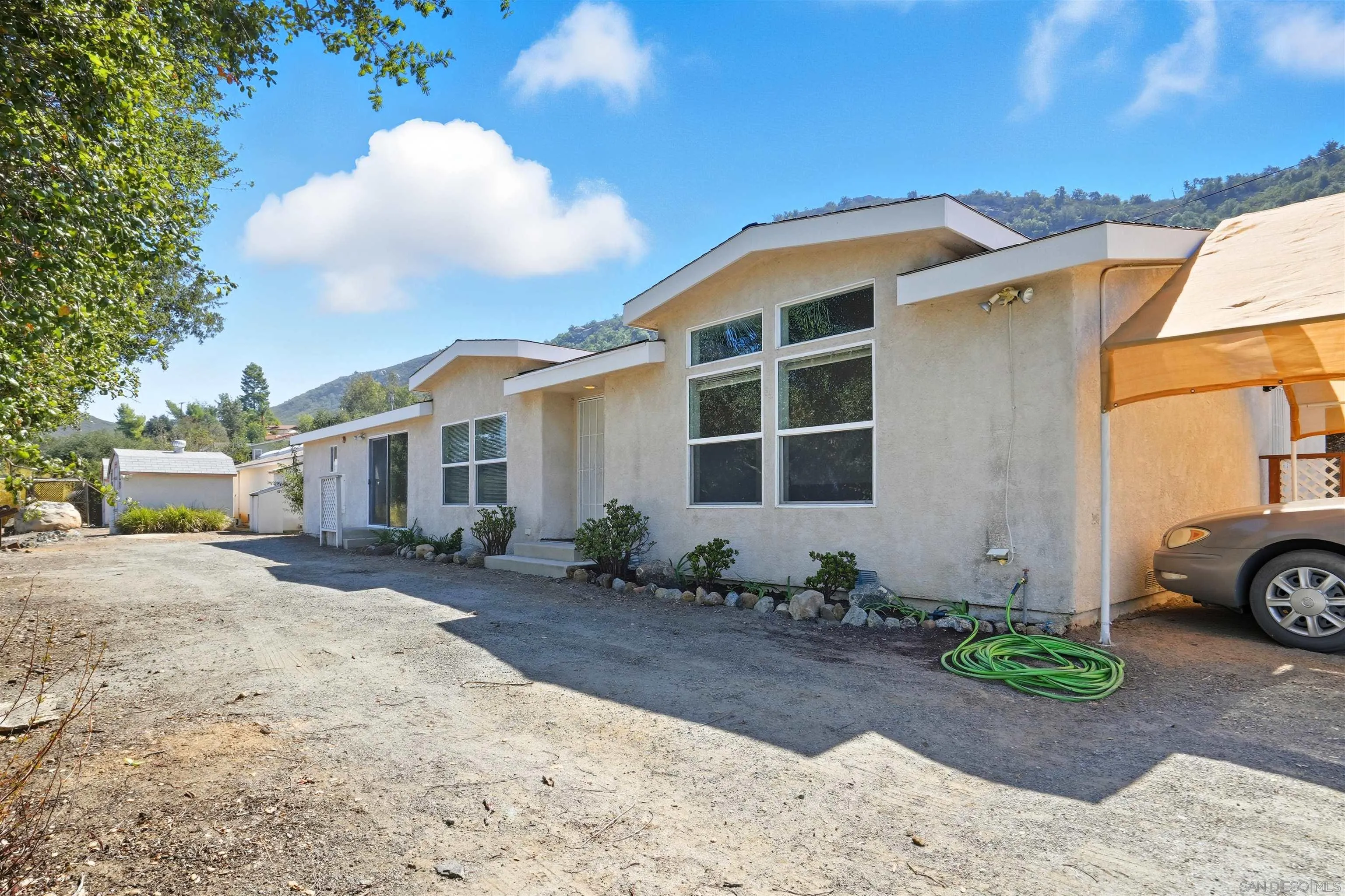 15453 Woods Valley Road Valley Center, CA 92082 - Photo 26 of 38 a front view of a house with a garden