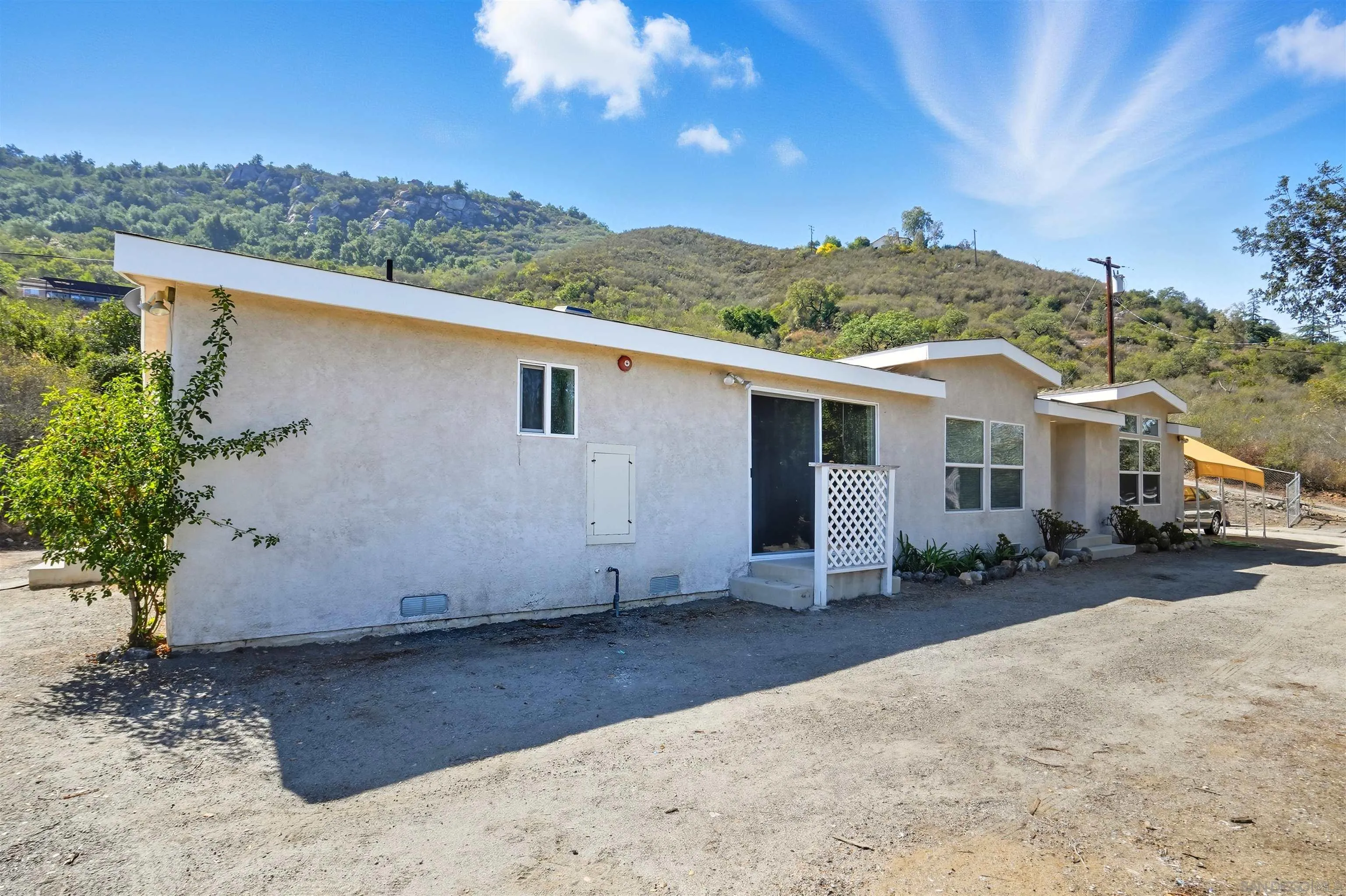 15453 Woods Valley Road Valley Center, CA 92082 - Photo 27 of 38 a view of a house with a backyard and mountain
