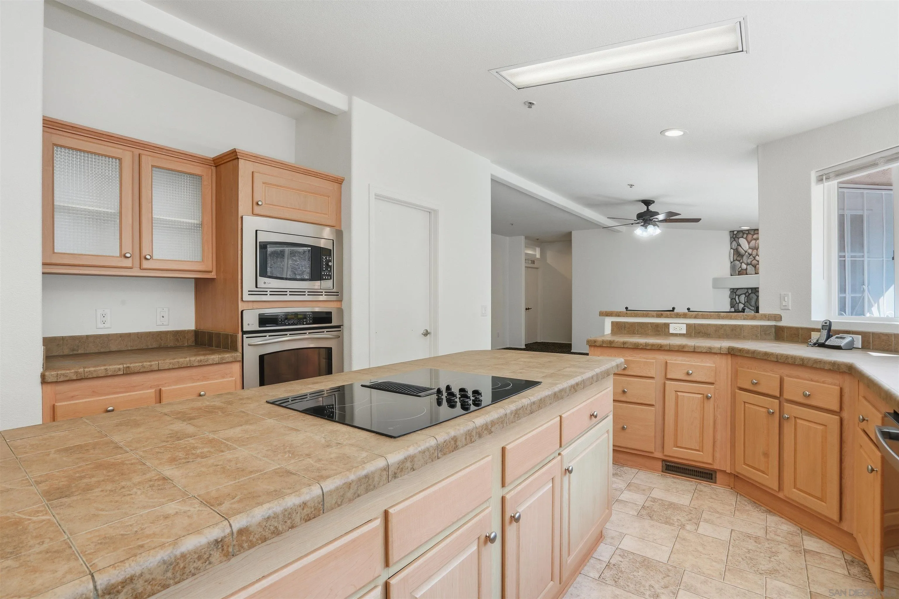 15453 Woods Valley Road Valley Center, CA 92082 - Photo 3 of 38 a kitchen with stainless steel appliances granite countertop a sink and dishwasher a stove with wooden floor
