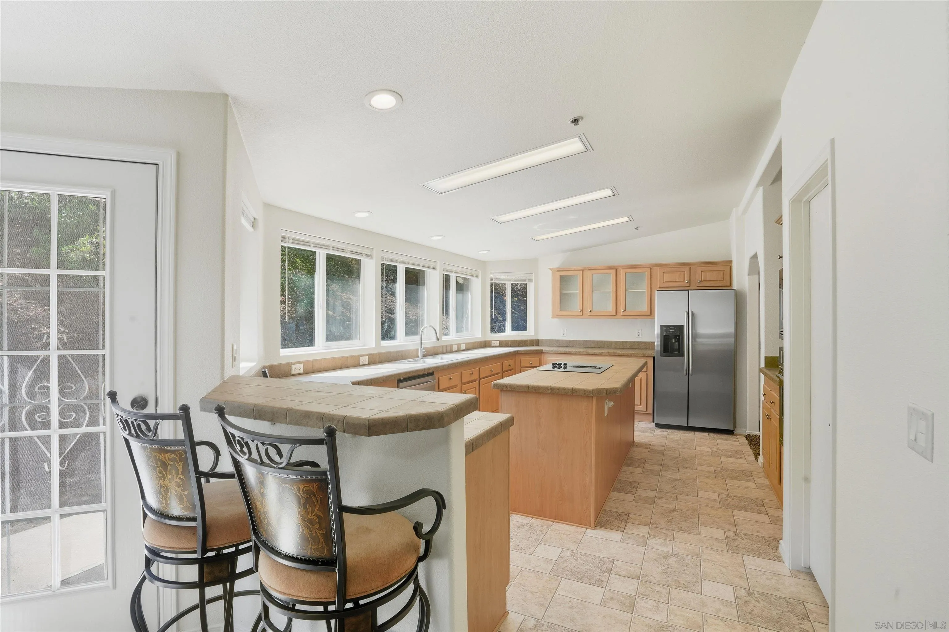 15453 Woods Valley Road Valley Center, CA 92082 - Photo 4 of 38 a kitchen with a table and chairs