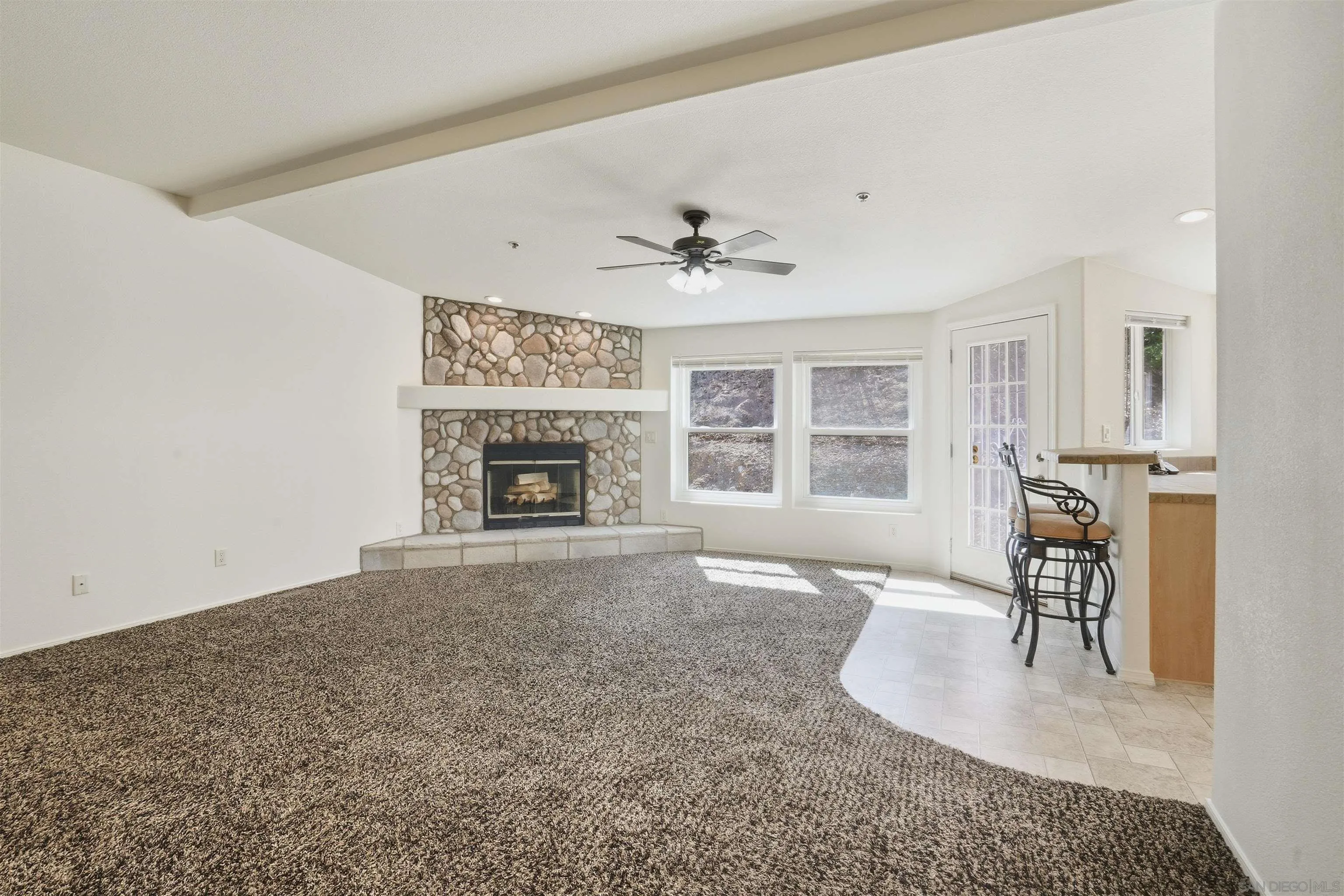 15453 Woods Valley Road Valley Center, CA 92082 - Photo 6 of 38 an entryway and livingroom with fireplace