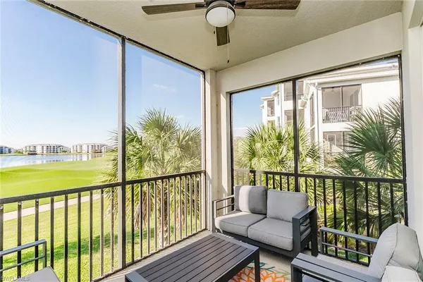 a view of a balcony with couches and wooden floor