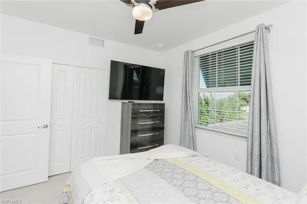 a bedroom with a bed and a window