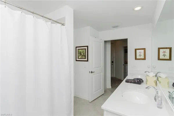a view of kitchen with cabinets and window