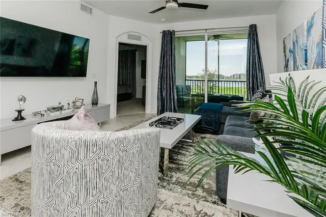 a living room with furniture kitchen view and a table