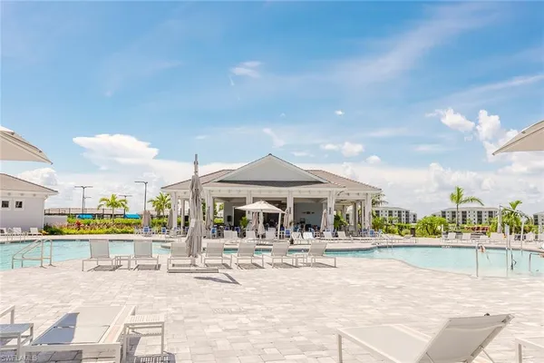 a view of swimming pool with outdoor seating and city view