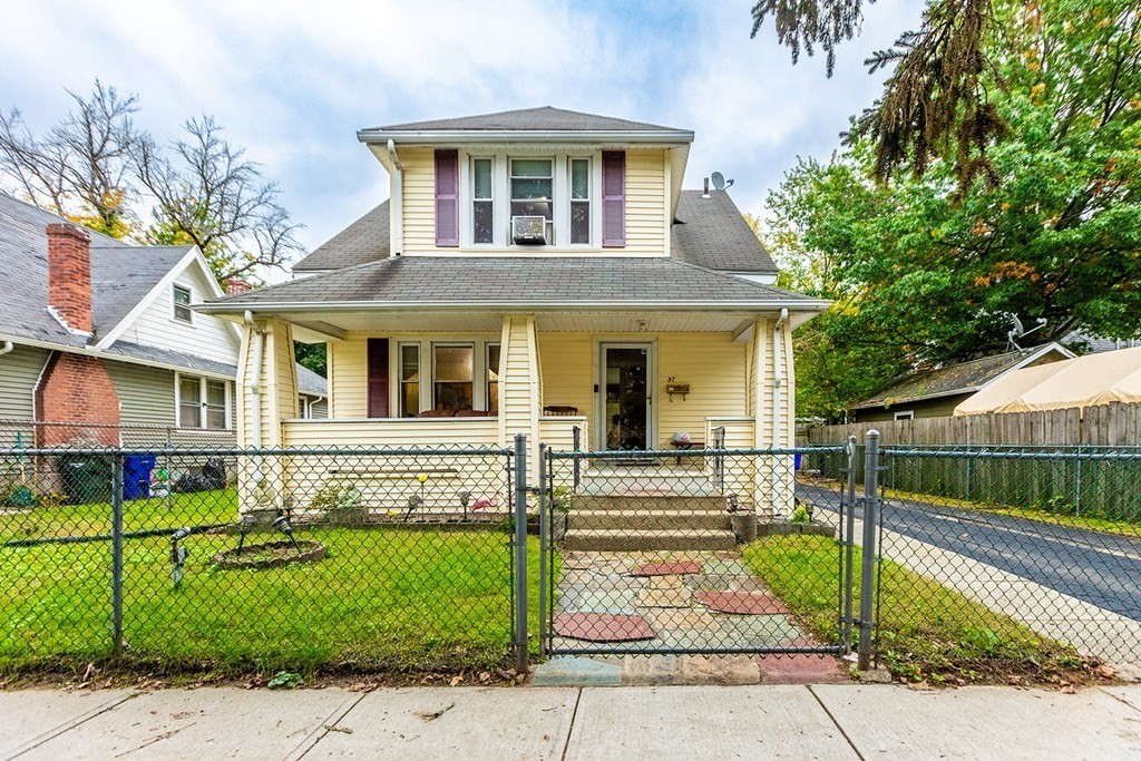a front view of a house with a garden