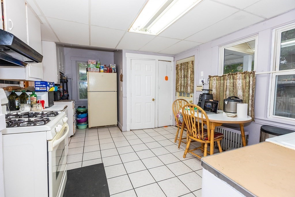 37 Alberta Street Springfield, MA 01108 - Photo 11 of 21 a kitchen with stainless steel appliances kitchen island granite countertop a refrigerator and a stove top oven