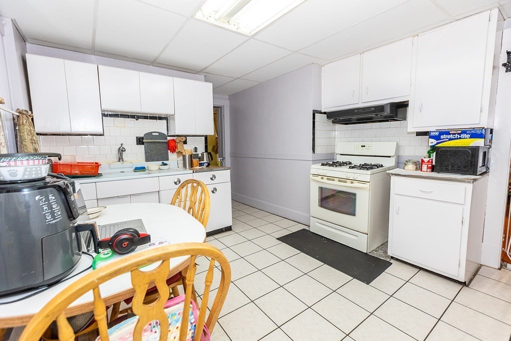 37 Alberta Street Springfield, MA 01108 - Photo 10 of 21 a kitchen with stainless steel appliances a stove a sink and white cabinets