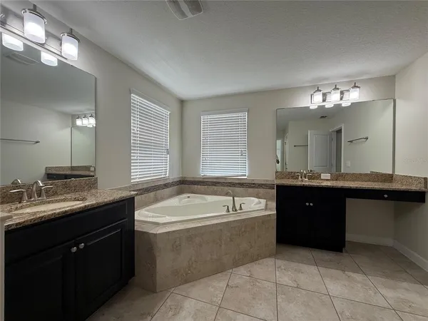 a large bathroom with a sink vanity and mirror