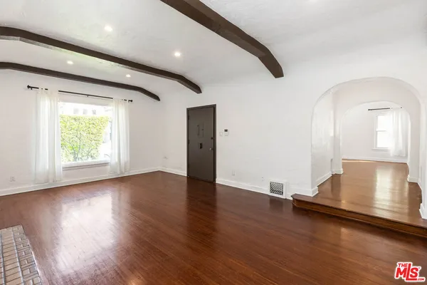 a view of a room with wooden floor and window