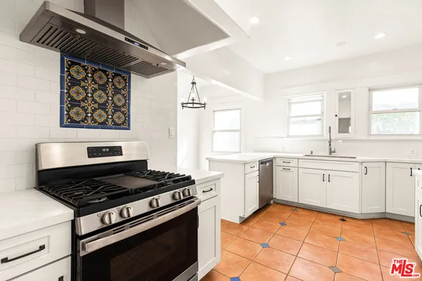 a kitchen with a stove a sink and a microwave