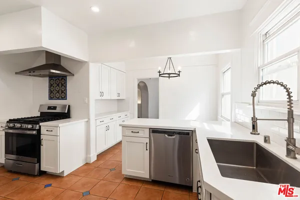 a kitchen with a sink cabinets and window
