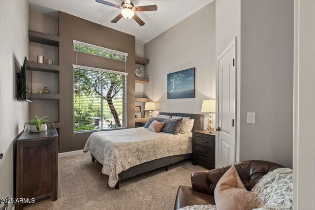 a dining room with furniture and a floor to ceiling window