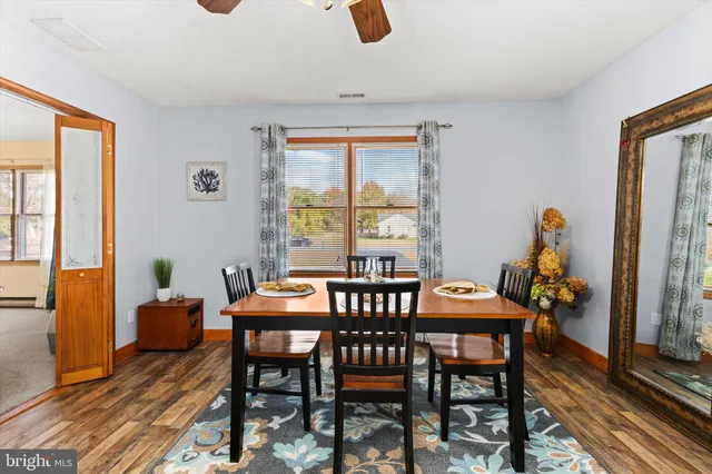 a dining room with furniture and window