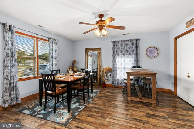 a view of a dining room with furniture window and wooden floor