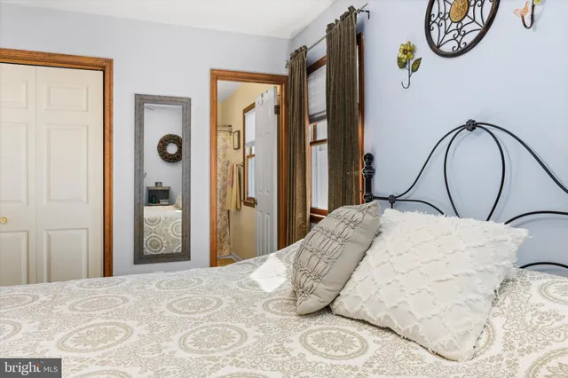 a bedroom with a bed and a mirror