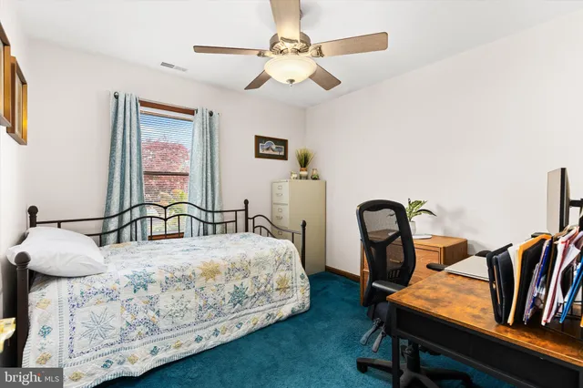 a bedroom with a bed a desk and chair