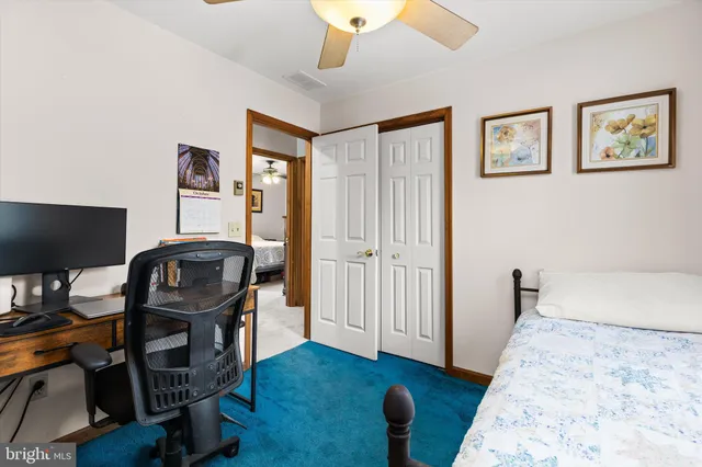 a view of a workspace with furniture and wooden floor