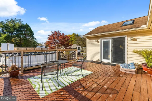 a balcony with wooden floor table and chairs