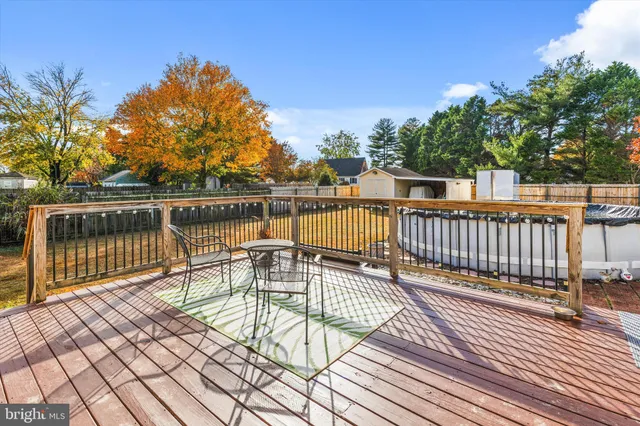 a view of a balcony with wooden floor and fence