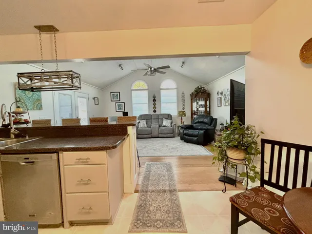 a view of a living room and kitchen