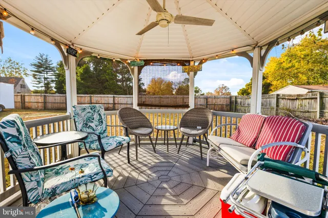 a balcony view with couple of chairs and a large window