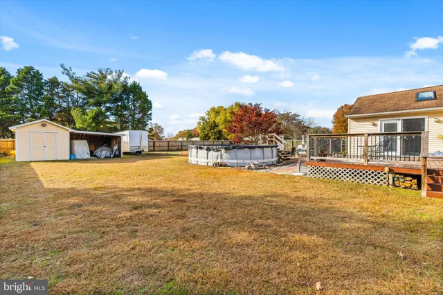 a house view with swimming pool in front of it