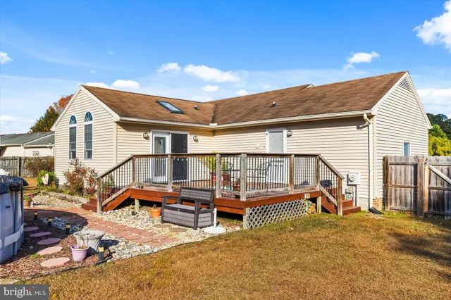 a backyard of a house with barbeque oven table and chairs