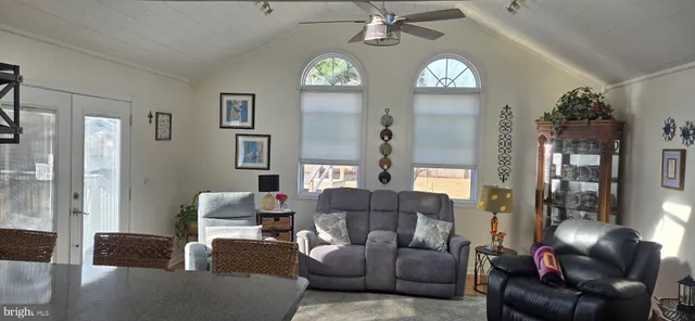 a living room with furniture a chandelier and a chandelier