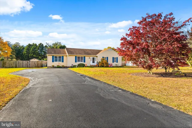 a view of swimming pool with outdoor seating and house in the background