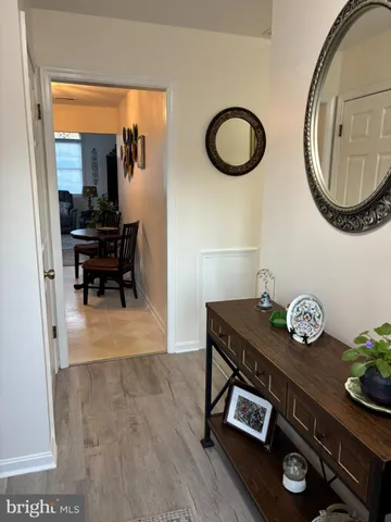 a dining room with furniture and a mirror