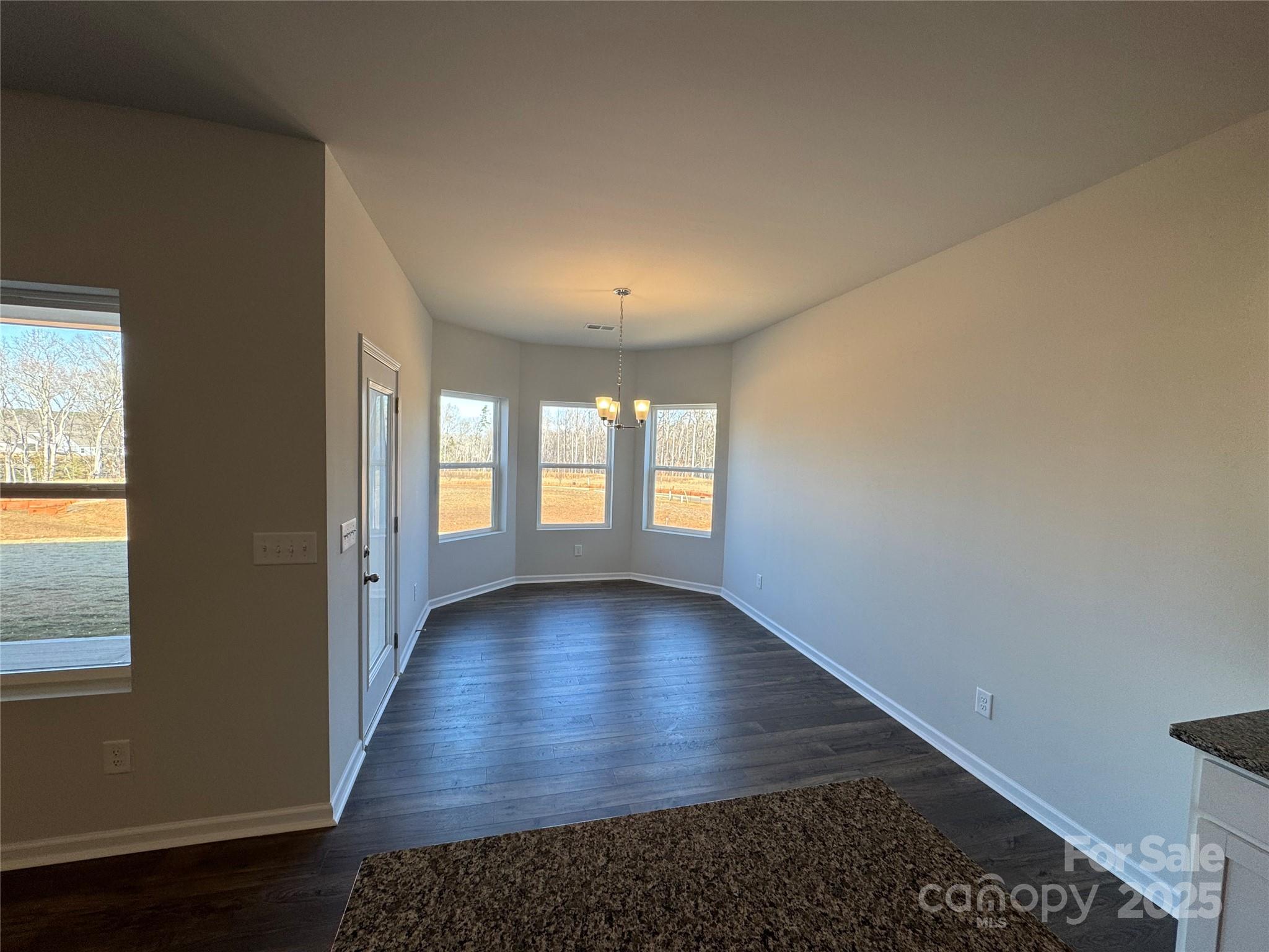 467 Brick House Road Gaffney, SC 29340 - Photo 5 of 17 an empty room with wooden floor and windows