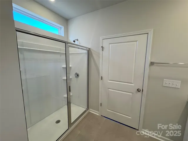 a bathroom with a shower and a sink