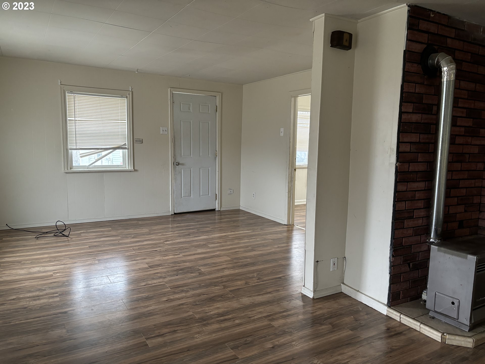 707 Southwest 15th Street Pendleton, OR 97801 - Photo 4 of 20 an empty room with wooden floor and windows
