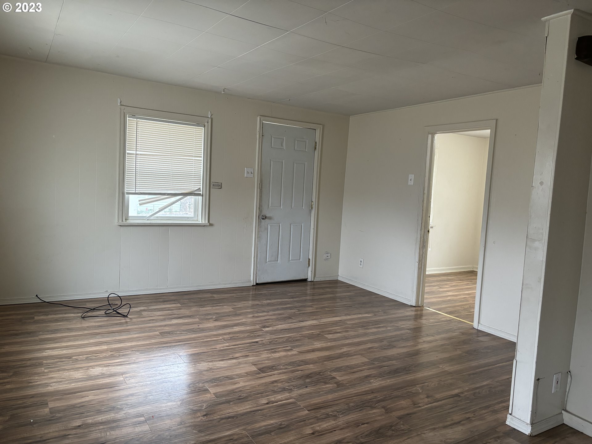 707 Southwest 15th Street Pendleton, OR 97801 - Photo 5 of 20 an empty room with wooden floor and windows