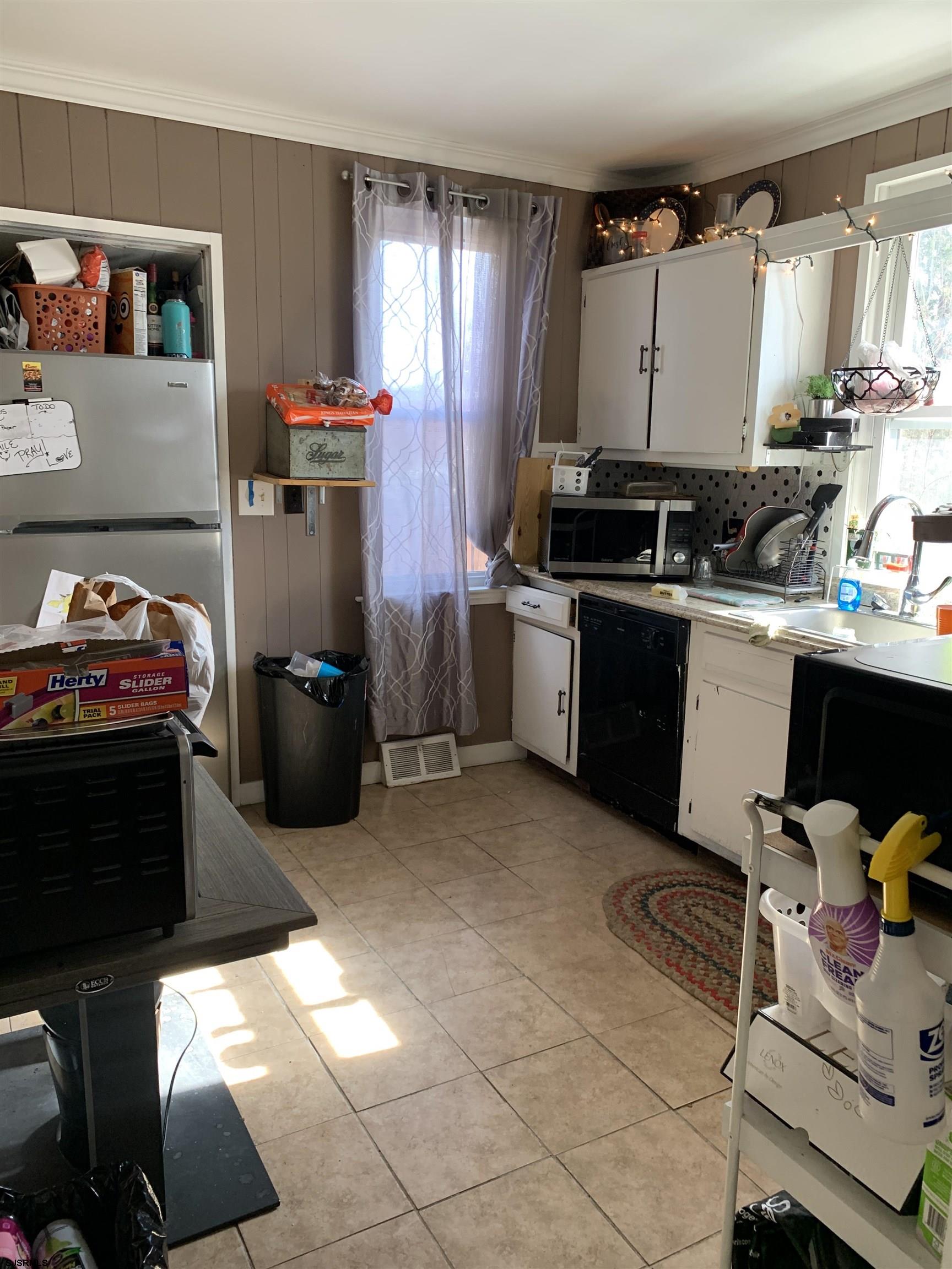 444 Shore Road Somers Point, NJ 08244 - Photo 10 of 15 a kitchen with sink cabinets and window