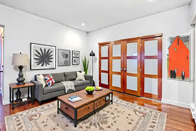 a living room with furniture and a window with wooden floor