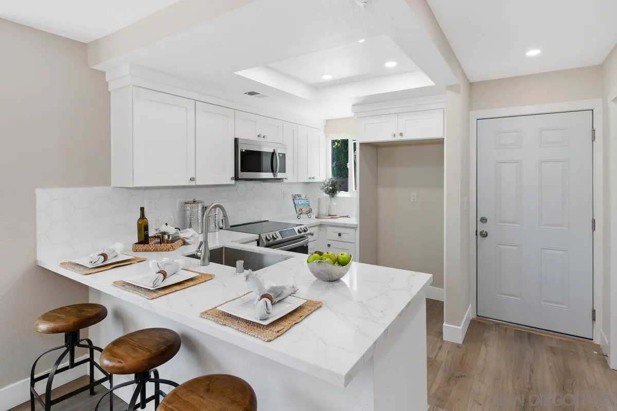 2301 Kings View Circle Spring Valley, CA 91977 - Photo 11 of 26 a kitchen with a dining table and chairs