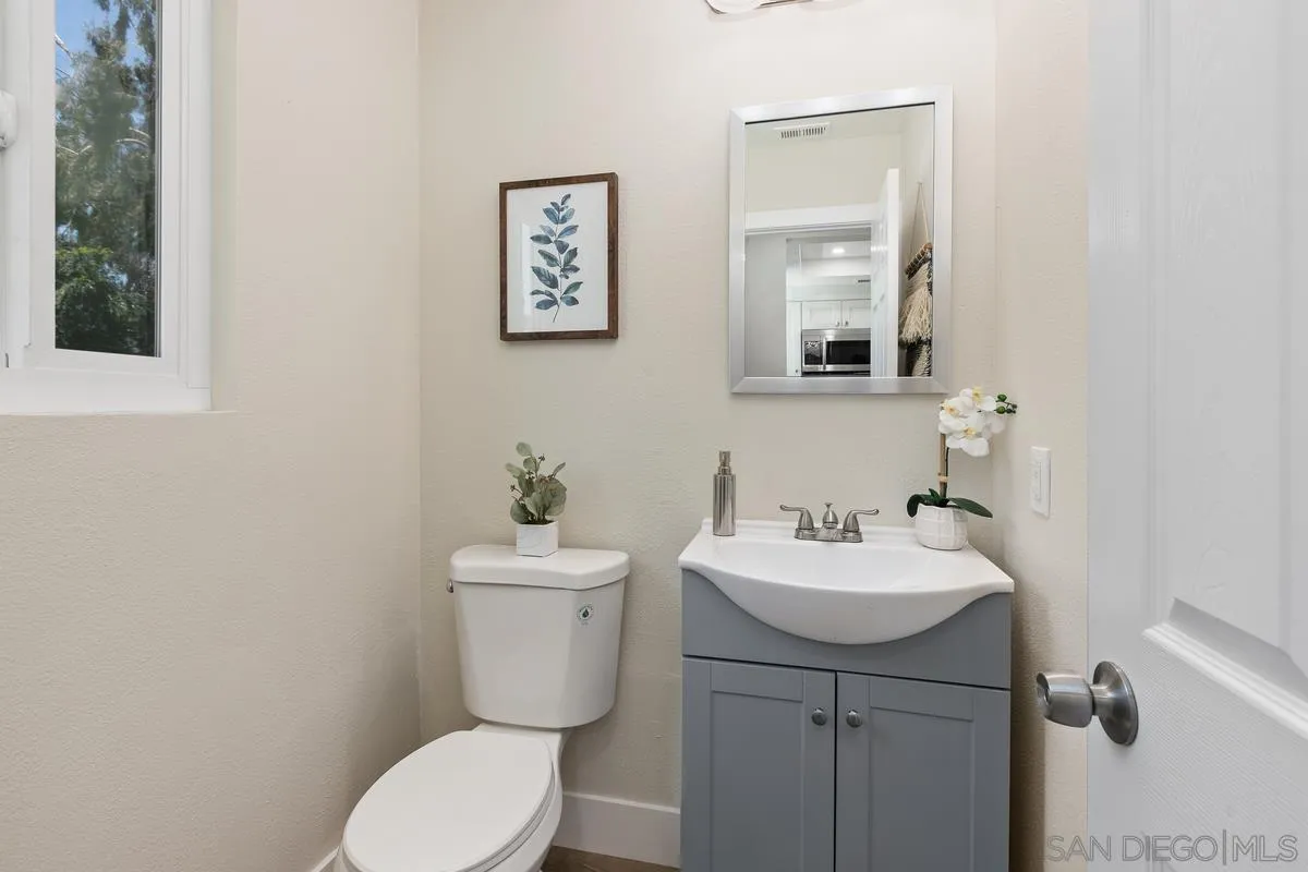 2301 Kings View Circle Spring Valley, CA 91977 - Photo 15 of 26 a bathroom with a sink mirror and toilet