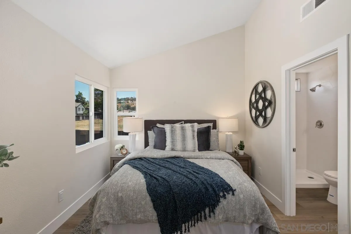 2301 Kings View Circle Spring Valley, CA 91977 - Photo 17 of 26 a bed room with a bed mirror and a window