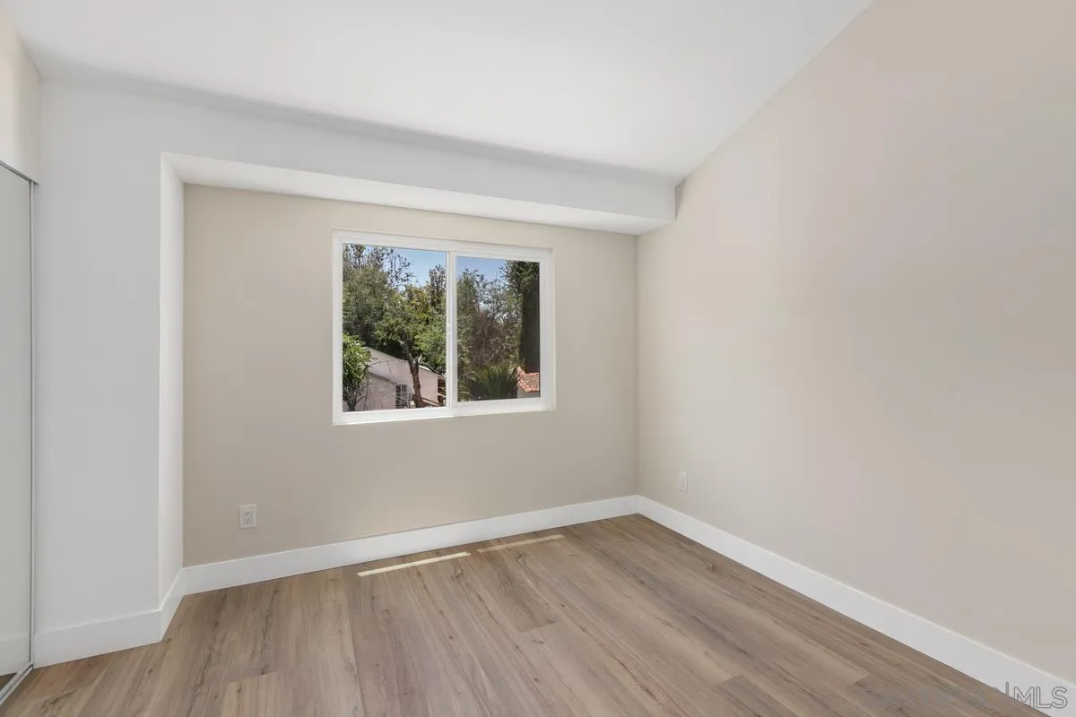 2301 Kings View Circle Spring Valley, CA 91977 - Photo 20 of 26 a view of an empty room with wooden floor and a window